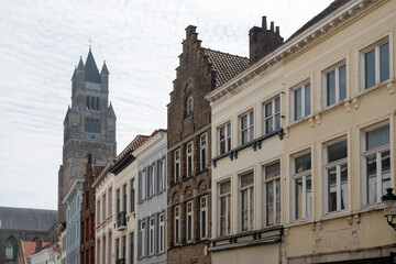 Fototapeta premium Medieval houses facades and rooftops and city tower with bells in the centre of Bruges, Flanders