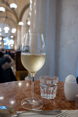 Lifestyle of beautiful Vienna, glass of cold white dry Austrian wine served in old Viennese-style cafe in Vienna, Austria