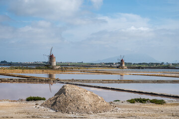 Sea saltworks, salt wind mills and pans, manually extracting high-quality salt, near Marsala and...