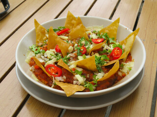 A bowl of vegan nachos and chlli con carne
