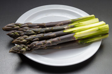 Garden or farm to table concept, fresh organic purple asparagus vegetables, seasonal foood, tasty healthy food