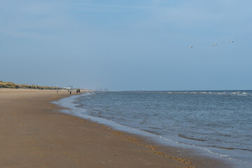 White sandy beach in cosy seaside holiday village on North Sea, built in belle epoque style in Flanders, De Haan or Le Coq sur Mer, Belgium