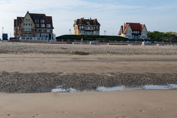 White sandy beach in cosy seaside holiday village on North Sea, built in belle epoque style in Flanders, De Haan or Le Coq sur Mer, Belgium