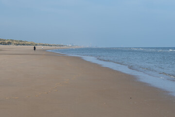 White sandy beach in cosy seaside holiday village on North Sea, built in belle epoque style in Flanders, De Haan or Le Coq sur Mer, Belgium