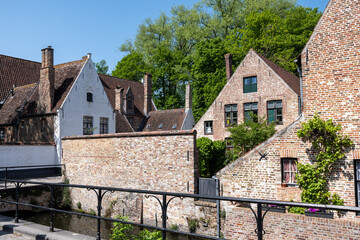 Medieval convent for nuns who weave lace in Bruges, Flanders, small white houses and a park inside the monastery walls, Belgium