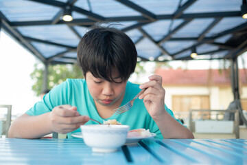 asian boy eating food, hungry kid