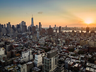 Sunset above New York Lower Manhattan buildings at summer. Warm Late afternoon light behind the clouds