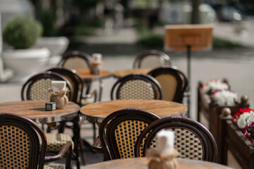 Cafe Tables Chairs: Outdoor cafe seating awaits customers for dining during the daytime.