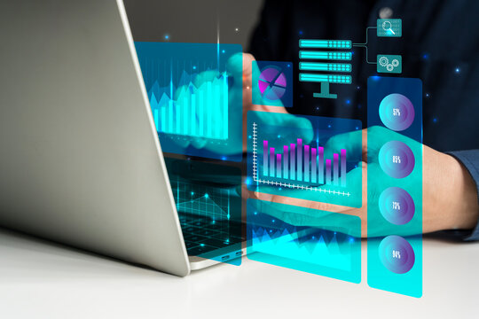 Businessman analyzing digital data with futuristic graphs, charts, and technology on virtual interface screen