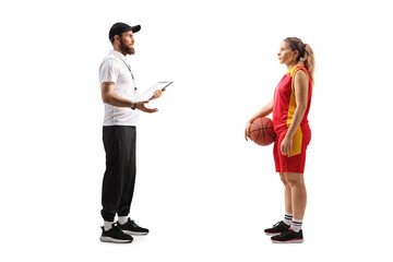 Full length profile shot of a sports coach talking to a female basketball player