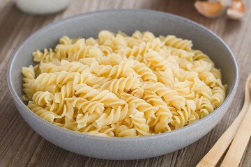 Cooked fusilli or rotini pasta served in bowl without sauce (Selective Focus, Focus in the middle...