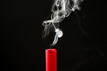 Beautifully shaped smoke rising from an extinguished candle wick.