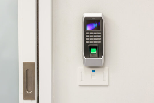 Fingers print scanner machine on wall at front door.
