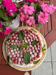 Strawberry pavlova cake decorated with fresh mint leaves