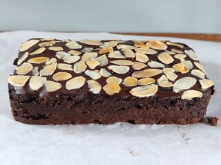 Side view texture of homemade sweet potato brownies on baking paper on a wooden cutting board