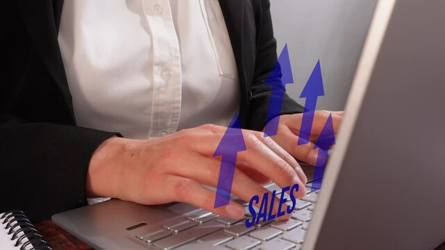  A woman's hands typing on her laptop with blue arrows pointing up and to the right, forming an arrow shape that says "SALES". The background is a neutral gray color, creating a professional atmospher