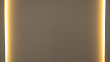 Minimalist wall background with warm ambient lighting on both sides. Soft golden glow creates elegant symmetry, ideal for interior design, mockups, or architectural lighting concepts.