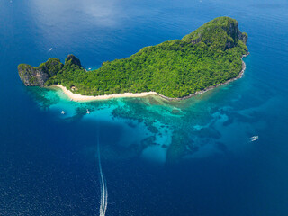 Helicopter Island with beach and blue sea with boats. El Nido, Philippines.