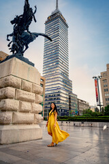Tourist woman in yellow dress at Torre Latinoamericana in Mexico City
