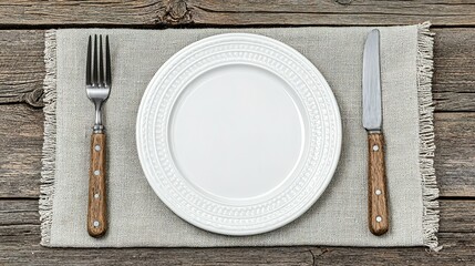 Empty plate and cutlery set on a linen placemat.