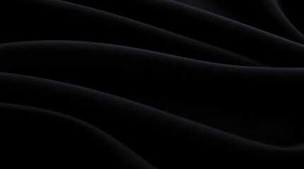 Fototapeta premium Black fabric drapes with subtle textures softly illuminated