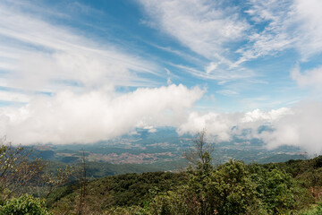 Scenic View from Mountain Summit with Clouds and Blue Sky
