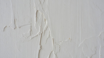 Textured white wall with detailed layered paint and scrapes