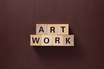 Artwork word written on wooden cubes on brown background