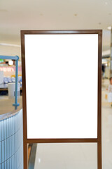 mockup white poster stand in front of blur background of a shopping mall