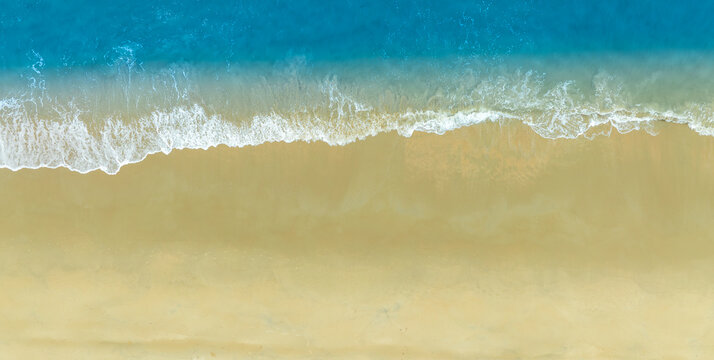 Nature of the beach and sea Summer with sunshine, sandy beaches, clear blue waters sparkling against the blue sky. On an island with good ecology and environment Background for summer vacation