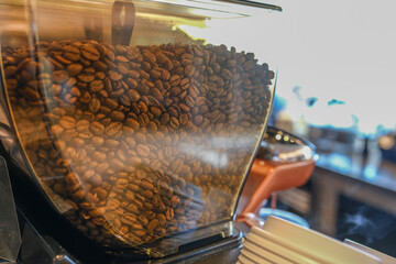 Fresh organic raw coffee beans in a coffee machine