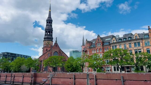 Hamburg, Germany - April 25, 2025: St. Michaels Church in Hamburg. View from above of St. Michael's Church in St. Pauli with St. Nikolai Memorial and the cityscape of Hamburg in the background. Harbor