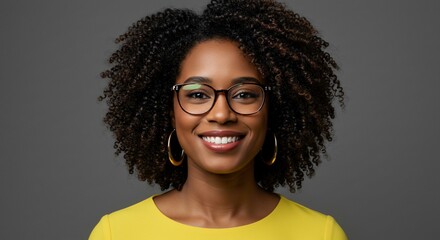 Smiling black woman portrait in yellow top against gray background for web use