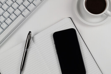 Work Desk Flat Lay with White Keyboard and Smartphone