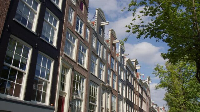 Typical Facade With Multiple Windows In Streetscape Of Amsterdam, Netherlands. POV Shot