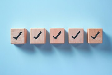 Obraz premium Five wooden cubes with black check marks lined up on a light blue surface casting shadows, symbolizing completion and approval