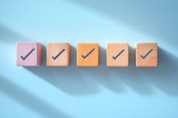 Obraz premium Five wooden blocks with check marks lined up on a light blue surface casting shadows, symbolizing completion and approval
