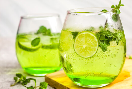 some mojito drinks with lime and mint leaves