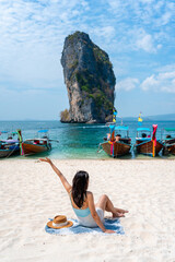 Young Asian woman relaxing and enjoying at beautiful white sand beach in Krabi Thailand, Travel on summer vacation