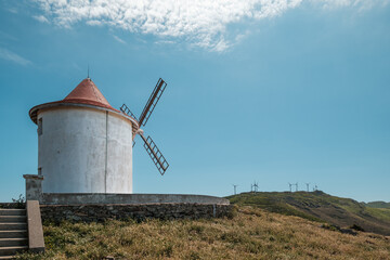 The Moulin Mattei windmill, built at the end of the 18th century, stands on the Cap Corse peninsula on the Mediterranean island of Corsica with modern electricity generating windmills in the distance