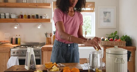 Smiling woman in kitchen peeling banana for healthy breakfast preparation, at home - Powered by Adobe