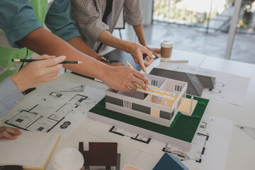 architects and engineers are discussing the design and structure of the upcoming building with the...