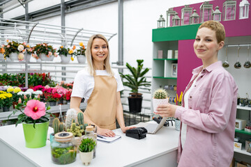 A florist shop scene features a sale transaction involving a smiling woman and a cashier with a cactus.