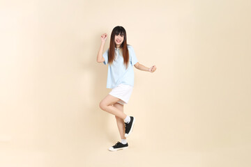 Fototapeta premium 20s Asian Woman in Light Blue Shirt and White Shorts