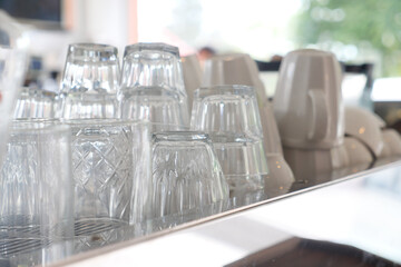 Glasses stacked on counter ready for service at cafe