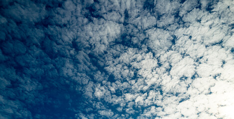 Cloudy skies. Cumulus clouds in sky. Cloud wallpaper. Sky background. Cloudy sky with sunlight. White clouds wallpaper. Blue sky and white clouds background. Idyllic fluffy clouds. Calm nature.