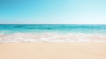 summer concept. Serene beach with gentle waves under a clear blue sky.