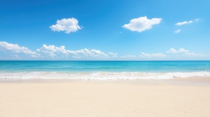 summer concept. Tranquil beach scene with clear blue sky and gentle waves.