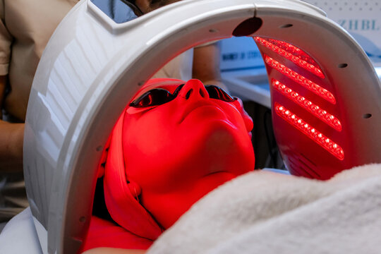Facial LED Light Therapy Treatment in a Beauty Clinic with Red Light and Eye Protection