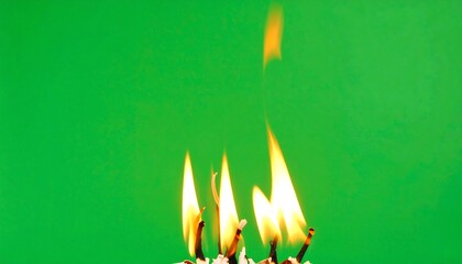 Burning matches against green background